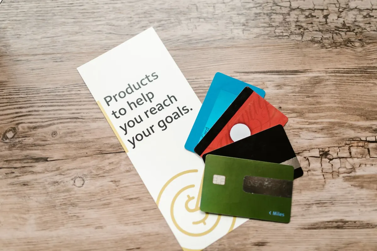 Several bank cards fanned out on a wooden table
