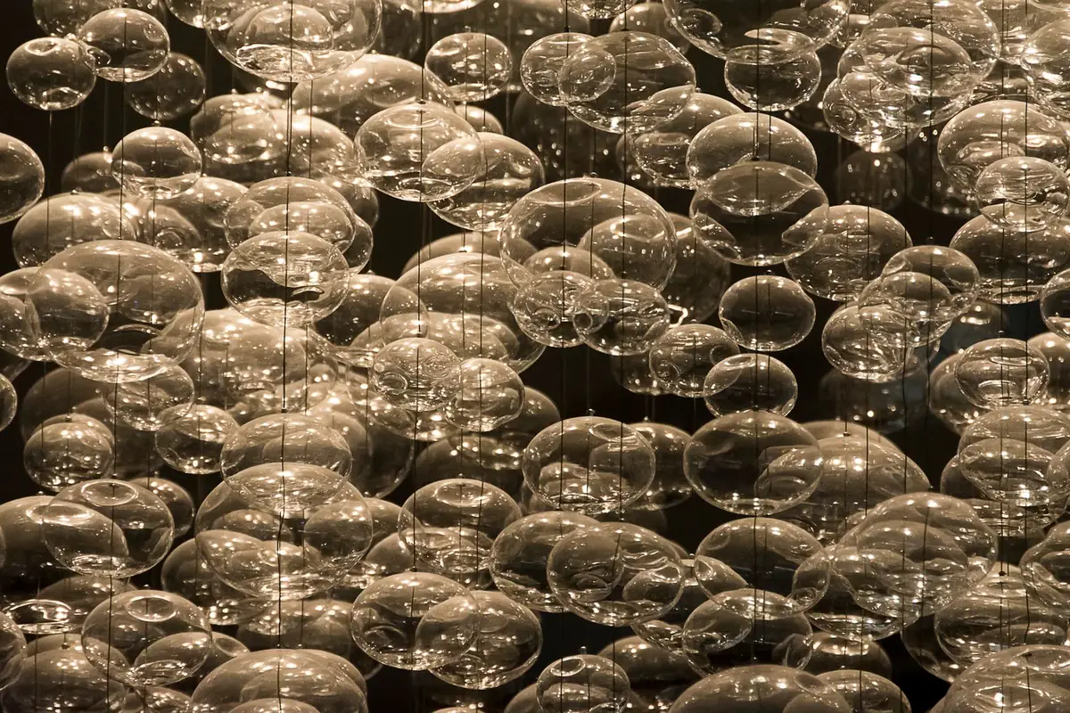 Stock photograph of transparent glass spheres suspended on strings.