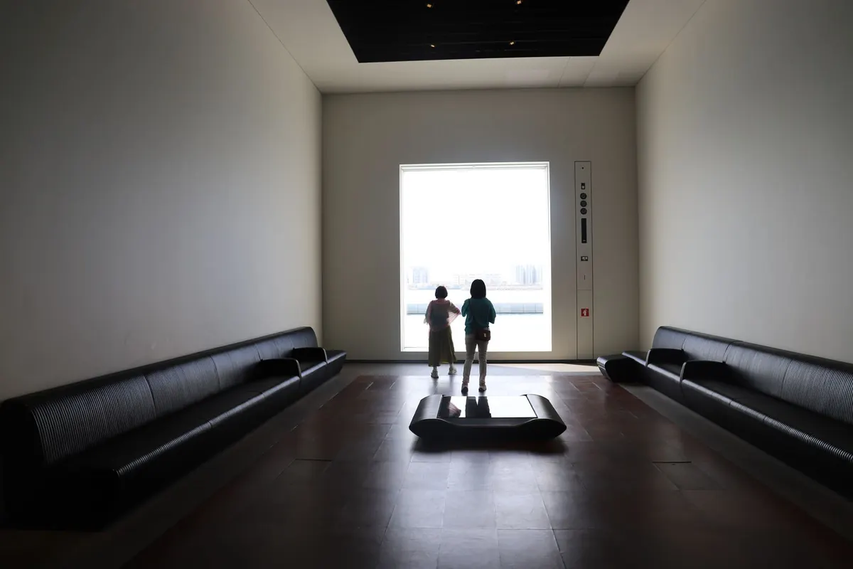 Stock photograph of two children looking out of a large gallery window. Not this museum.