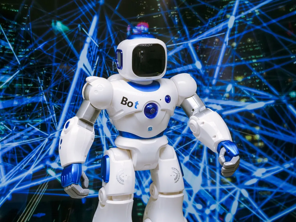 Stock photograph of a white humanoid robot lit by blue lights. Not the Shenzhen robot street.