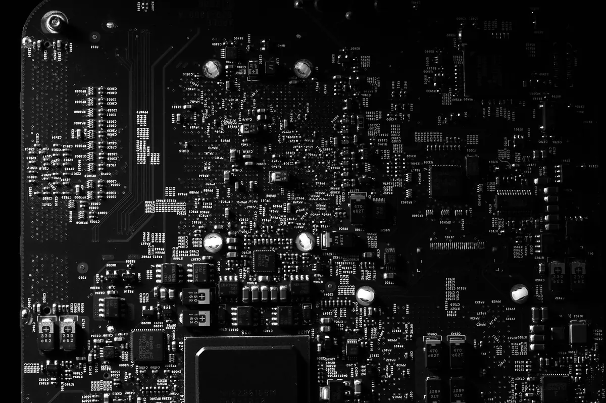 Close view of a bare printed circuit board covered in surface-mounted components