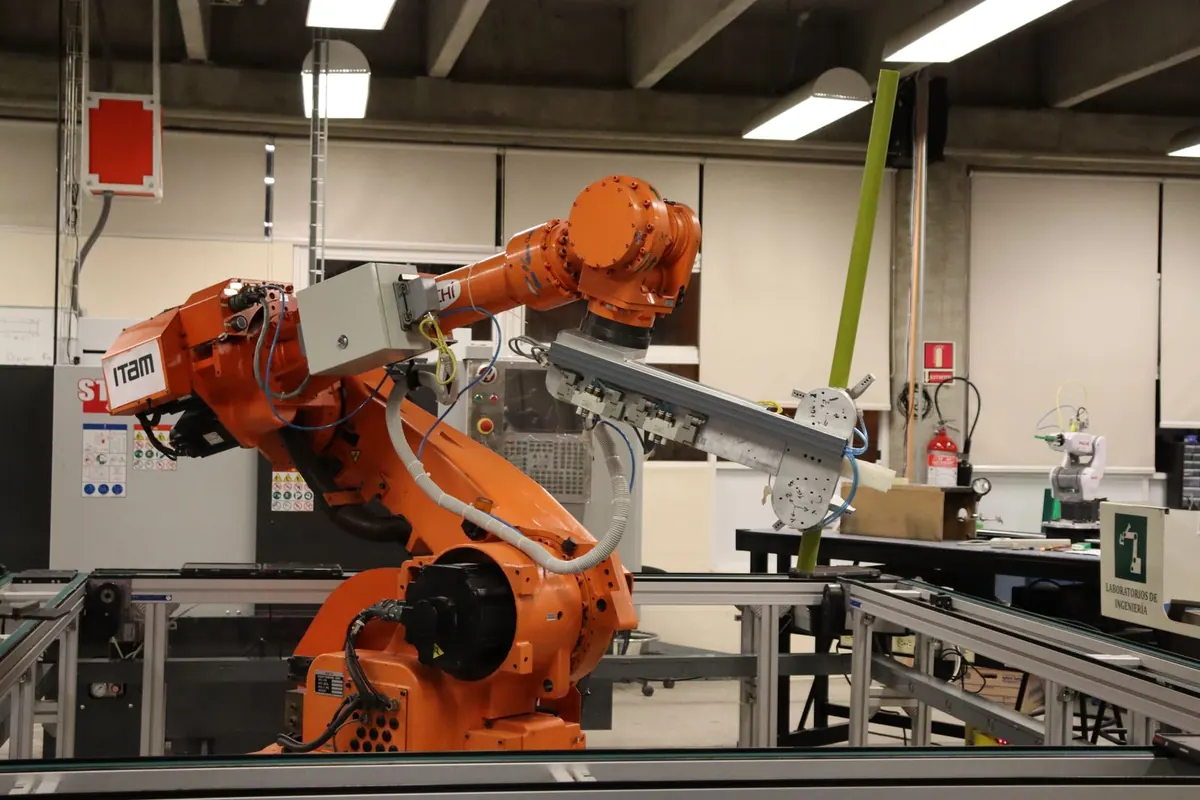 An industrial robotic arm on a workbench in an engineering laboratory